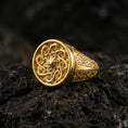 Load image into Gallery viewer, Gold plated spiral sun signet ring with sculpted swirl pattern and geometric side engravings, product-only macro photo on black volcanic rock

