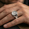 Load image into Gallery viewer, Polished silver triskelion signet ring on the finger, wearable shot emphasizing the octagonal face and clean geometric band
