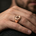 Load image into Gallery viewer, Rose gold plated compass ring worn on a finger, close-up lifestyle photo showcasing the compass face, dotted border, and smooth band
