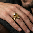 Load image into Gallery viewer, Gold plated skull ring worn on a finger, close-up lifestyle image showing the smooth skull top and bold jaw detailing
