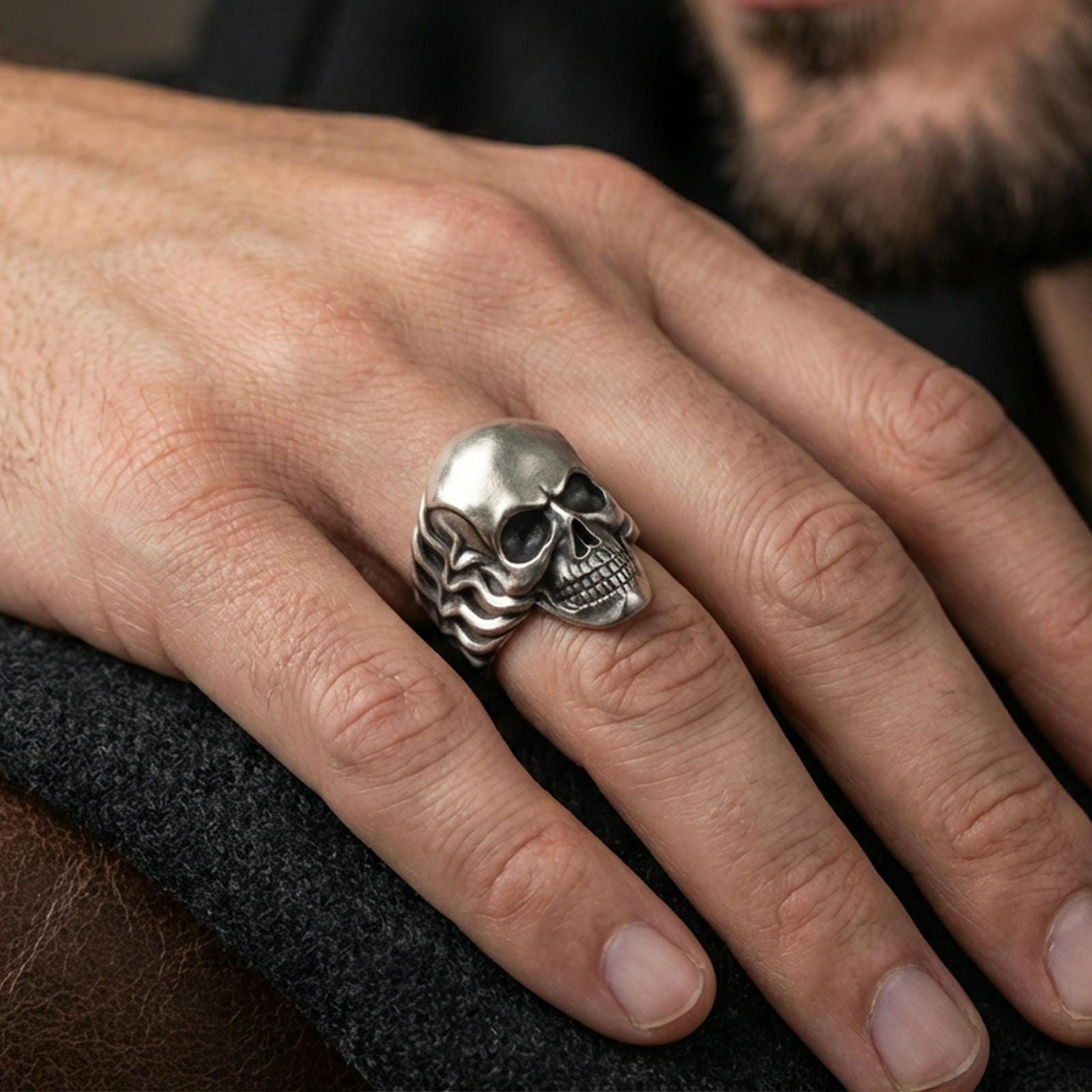 Oxidized skull ring worn on a finger, lifestyle close-up highlighting the smooth dome head and darkened recessed details