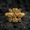 Load image into Gallery viewer, Gold plated Celtic knot cross ring with raised braided knot detailing and high-contrast relief, product-only macro image on black volcanic rock
