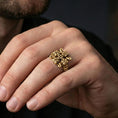 Load image into Gallery viewer, Gold plated Celtic knot cross ring worn on a finger, close-up lifestyle image showing the raised knotwork relief and statement cross design
