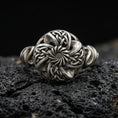 Load image into Gallery viewer, Oxidized sterling silver Celtic windflower ring with openwork floral rosette and interlaced knot details, macro product photo on black volcanic rock
