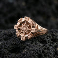 Load image into Gallery viewer, Rose gold plated compass ring with sculpted navigation star and cardinal points, close-up product shot on volcanic rock
