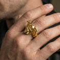 Load image into Gallery viewer, Gold plated biker skull ring worn on a finger, close-up lifestyle image emphasizing the goggles and skeletal arm design
