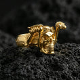 Load image into Gallery viewer, Gold plated biker skull ring with aviator goggles and detailed skeletal hands gripping bars, product-only macro image on volcanic rock
