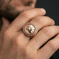 Load image into Gallery viewer, Rose gold plated ancient coin signet ring worn on a finger, close-up lifestyle image showing the classical profile and bold bezel frame
