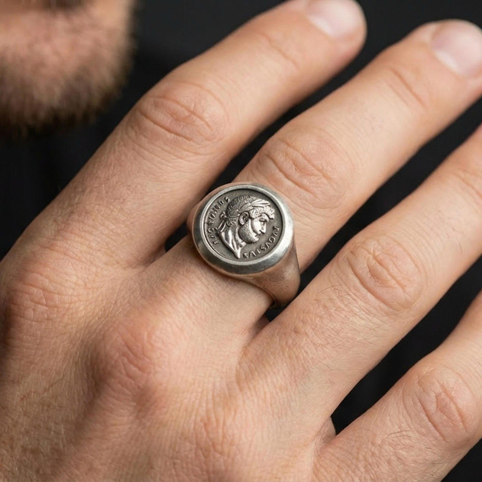 Oxidized Roman coin ring worn on a finger, close-up lifestyle shot highlighting the Augustus profile and Latin inscription
