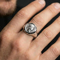Load image into Gallery viewer, Polished silver Augustus coin signet ring on the finger, wearable close-up focusing on the raised portrait relief and coin edge
