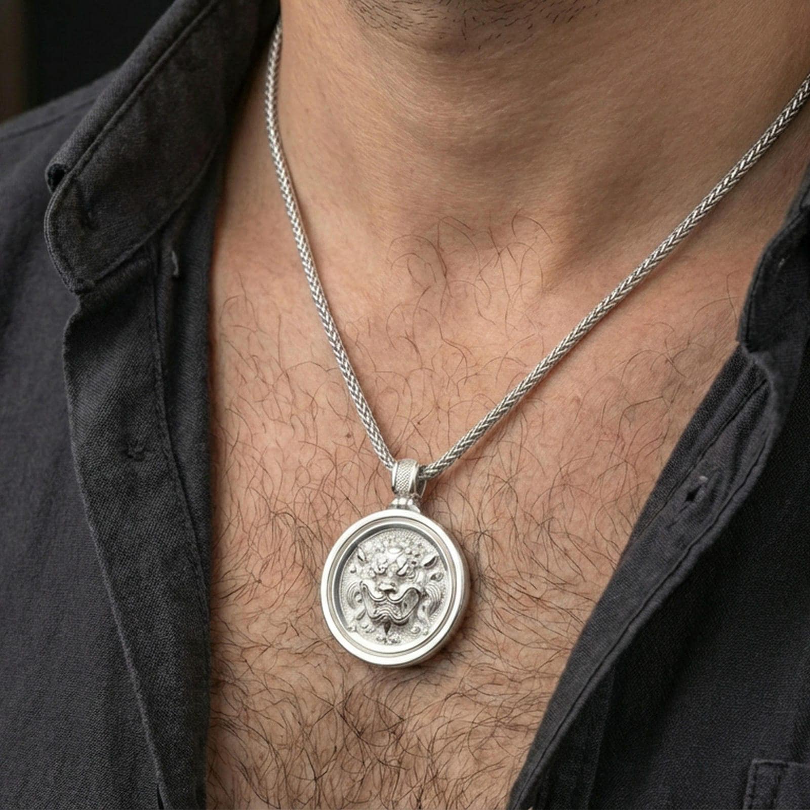 Polished silver guardian lion medallion necklace worn on neck, clean lifestyle framing, reflective metal and crisp details