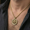 Load image into Gallery viewer, Gold plated guardian lion medallion necklace worn on neck, premium styling, rotating medallion disk as focal point

