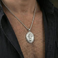 Load image into Gallery viewer, Polished silver Medusa medallion necklace worn on neck, clean lifestyle framing, reflective finish and sharp details
