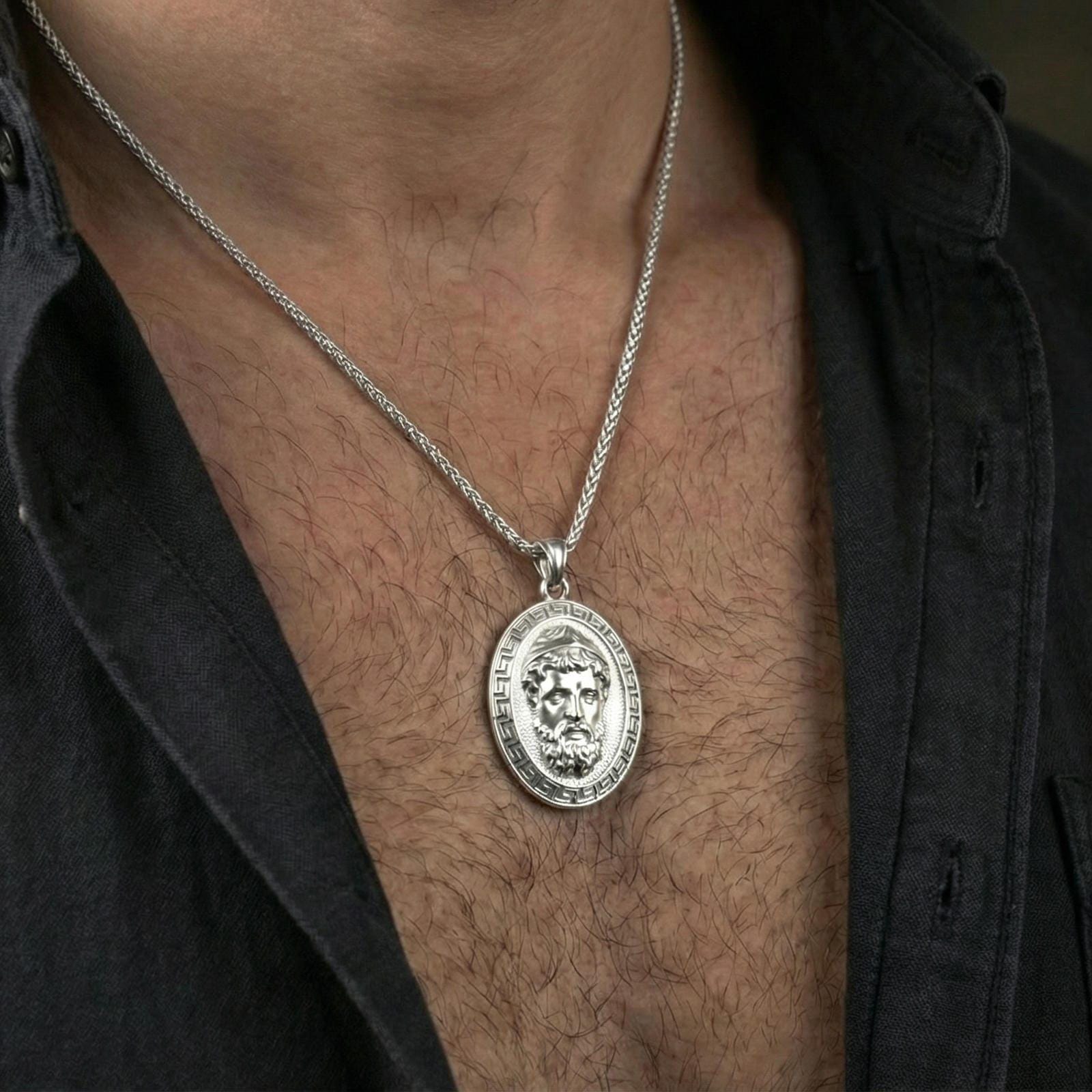 Polished silver Medusa medallion necklace worn on neck, clean lifestyle framing, reflective finish and sharp details