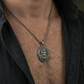Load image into Gallery viewer, Oxidized Medusa pendant necklace worn on neck, lifestyle close-up, Greek key medallion centered on chain

