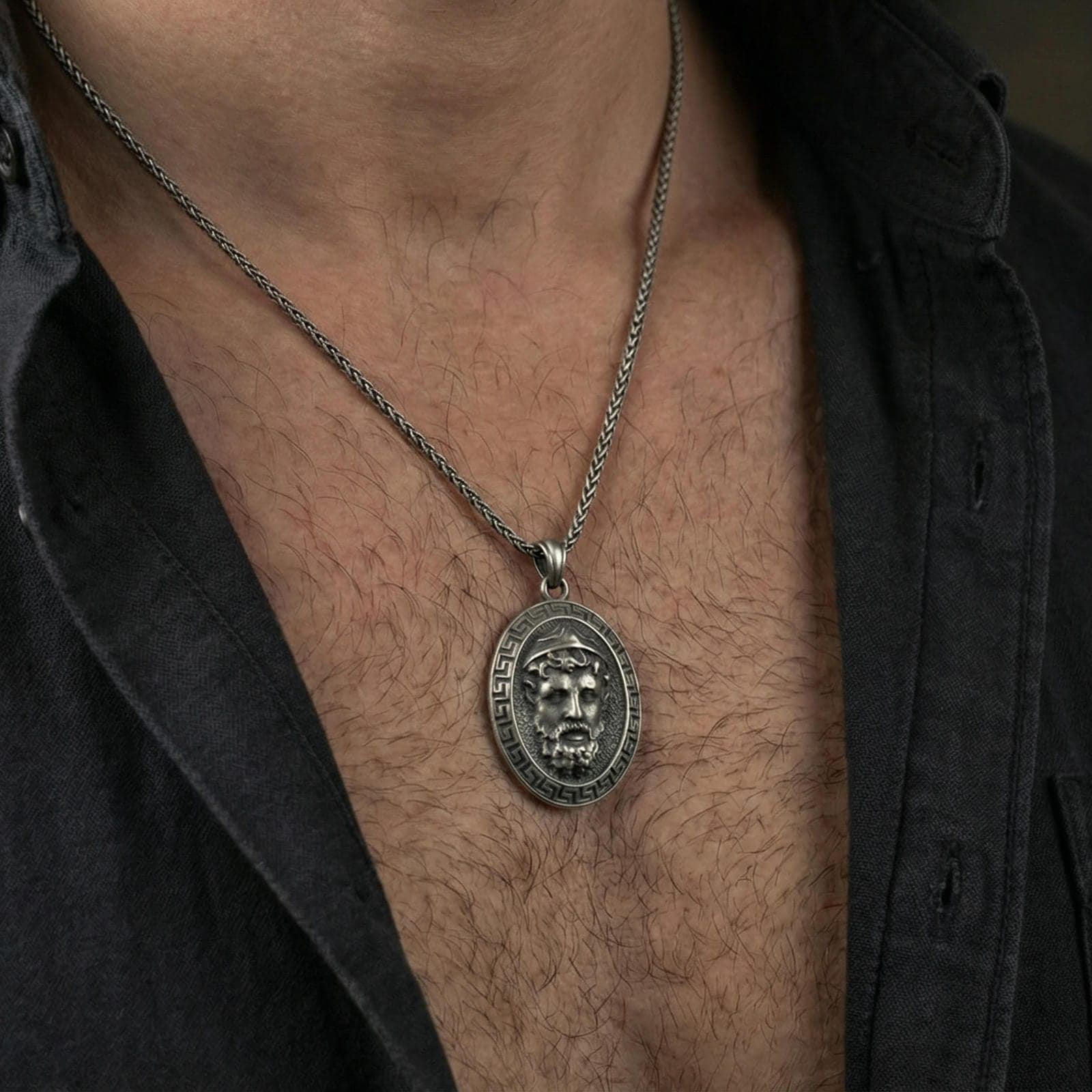 Oxidized Medusa pendant necklace worn on neck, lifestyle close-up, Greek key medallion centered on chain