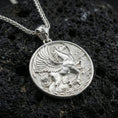 Load image into Gallery viewer, Polished silver winged Pegasus pendant on volcanic rock, crisp feather and musculature detail, close-up studio lighting
