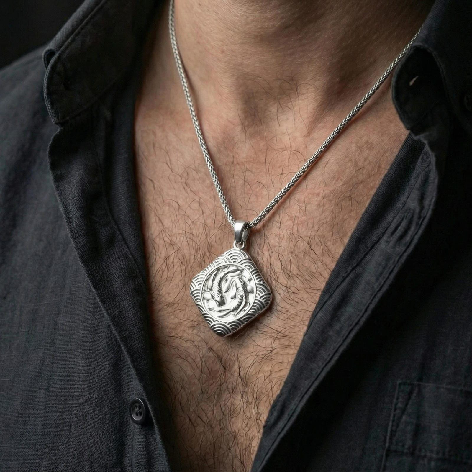 Polished silver koi fish necklace worn on neck, clean lifestyle framing, reflective finish and sharp engraved details