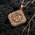 Load image into Gallery viewer, Rose gold plated koi fish pendant on volcanic rock, textured lava stone background, detailed koi relief and wave motif

