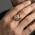 Load image into Gallery viewer, Rose gold plated fox head signet ring worn on finger, lifestyle wear shot, warm plating tone and sculpted depth

