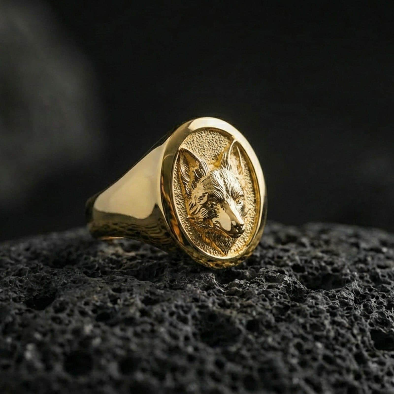 Gold plated fox head signet ring on volcanic rock, premium studio lighting, animal totem motif with sharp relief detail