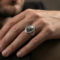 Load image into Gallery viewer, Oxidized gorilla head signet ring worn on finger, lifestyle close-up, round face centered with rugged masculine styling
