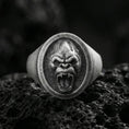Load image into Gallery viewer, Oxidized sterling silver gorilla head signet ring on volcanic rock, roaring face relief with sharp fangs, macro studio shot
