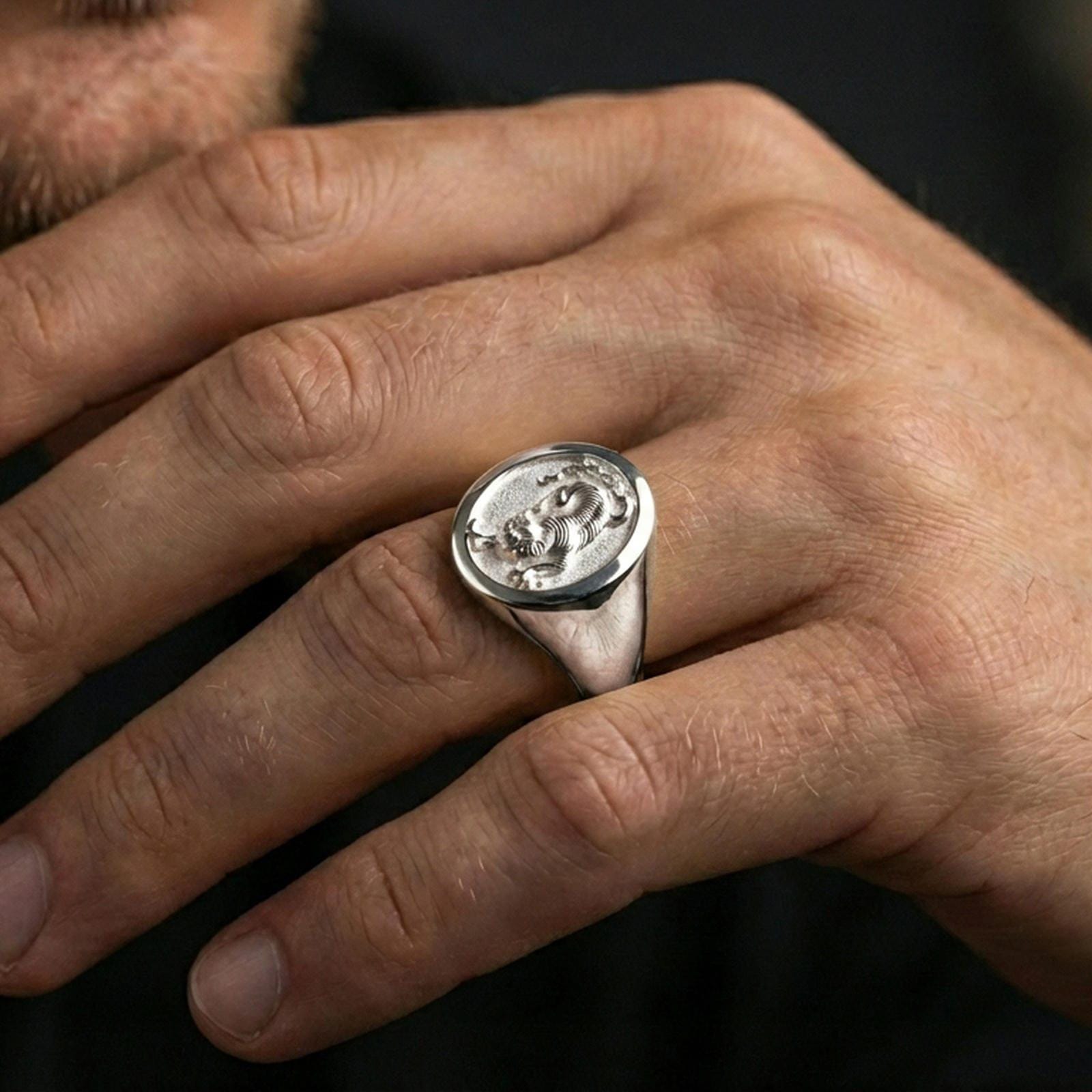 Polished silver tiger signet ring worn on finger, clean lifestyle framing, reflective finish and sharp relief definition