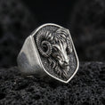 Load image into Gallery viewer, Oxidized sterling silver ram head signet ring on volcanic rock, curved horn relief and textured background, macro product shot
