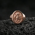 Load image into Gallery viewer, Rose gold plated octopus signet ring on volcanic rock, sculpted octopus crest signet ring with high-relief tentacle details, luxury close-up
