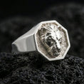 Load image into Gallery viewer, Polished silver lioness signet ring on volcanic rock, octagonal bezel with sculpted lioness portrait and crisp edge lines, close-up jewelry shot
