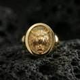 Load image into Gallery viewer, Gold plated tiger signet ring on volcanic rock, oval signet with fierce tiger head emblem and recessed textured field, premium studio lighting
