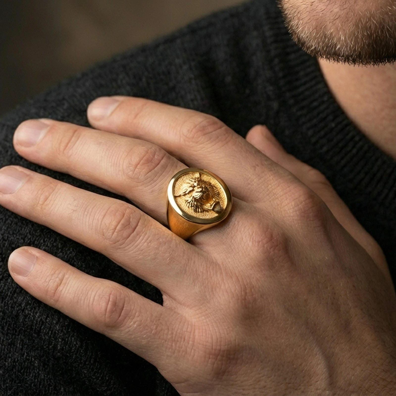 Gold plated tiger oval signet ring worn on finger, premium lifestyle photo, statement tiger totem ring with detailed facial carving