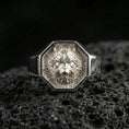 Load image into Gallery viewer, Polished silver wolf signet ring on volcanic rock, octagon bezel with detailed wolf portrait and clean sharp edges, close-up jewelry shot
