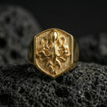 Load image into Gallery viewer, Gold plated octopus signet ring on volcanic rock, shield-shaped nautical emblem with detailed tentacle texture and deep contrast field, studio macro lighting
