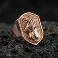 Load image into Gallery viewer, Rose gold plated tiger signet ring on volcanic rock, shield tiger crest signet with engraved stripe details and rugged recessed background, luxury product photo
