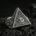 Load image into Gallery viewer, Oxidized sterling silver triangle signet ring with all-seeing eye relief and ornate scroll engravings, macro shot on black volcanic rock

