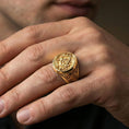 Load image into Gallery viewer, Gold plated square and compass Masonic ring worn on a finger, lifestyle macro emphasizing the engraved signet face
