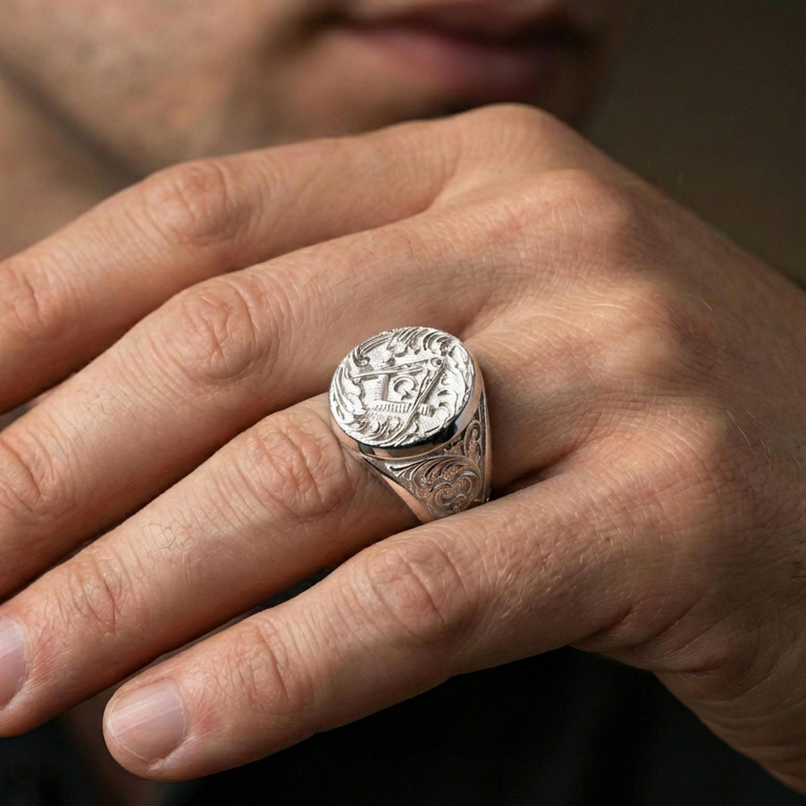 Polished silver Freemason ring on the finger, wearable close-up showing the raised “G” and detailed scrollwork