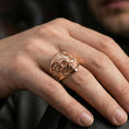 Load image into Gallery viewer, Rose gold plated Freemason skull ring on the finger, macro lifestyle photo emphasizing the ornate engraving and raised emblem
