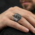 Load image into Gallery viewer, Oxidized horned oni mask ring worn on a finger, close-up lifestyle shot highlighting the deep carved demon face relief
