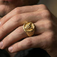 Load image into Gallery viewer, Gold plated oni mask statement ring with seigaiha wave shoulders worn on a finger, close-up lifestyle photo focusing on the relief and texture
