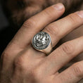 Load image into Gallery viewer, Polished silver Japanese oni mask ring on the finger, wearable macro focusing on the carved demon face and surrounding details
