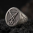 Load image into Gallery viewer, Oxidized sterling silver Lucifer sigil signet ring with raised occult symbol on a textured face, macro on black volcanic rock
