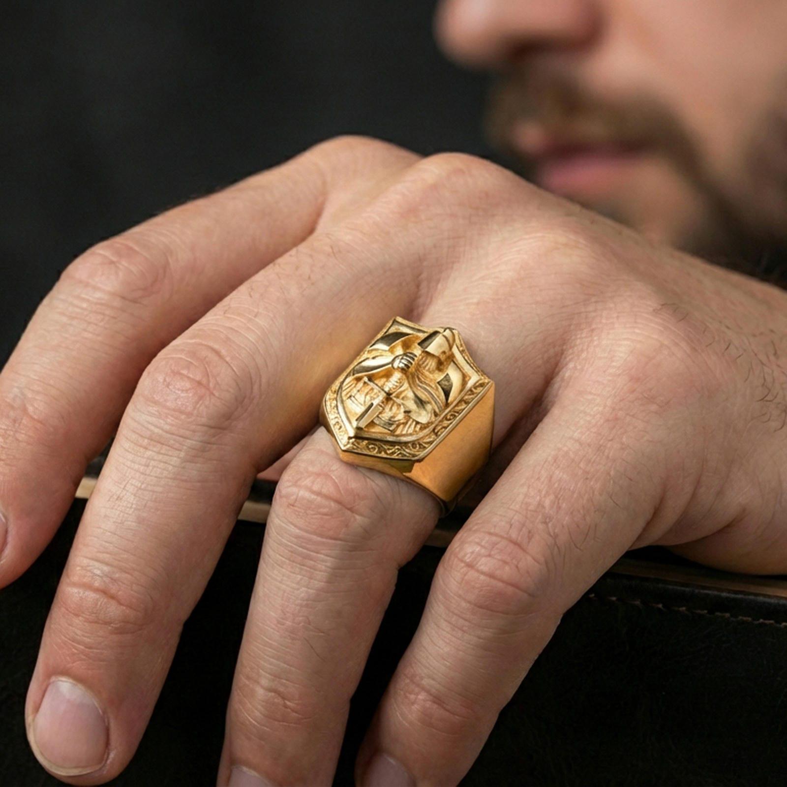 Gold plated finish knight signet ring worn on a finger, close-up lifestyle photo focusing on the shield crest and bold medieval design