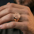 Load image into Gallery viewer, Rose gold plated finish Valknut signet ring on the finger, macro lifestyle shot showcasing the octagonal frame and engraved Viking knot motif
