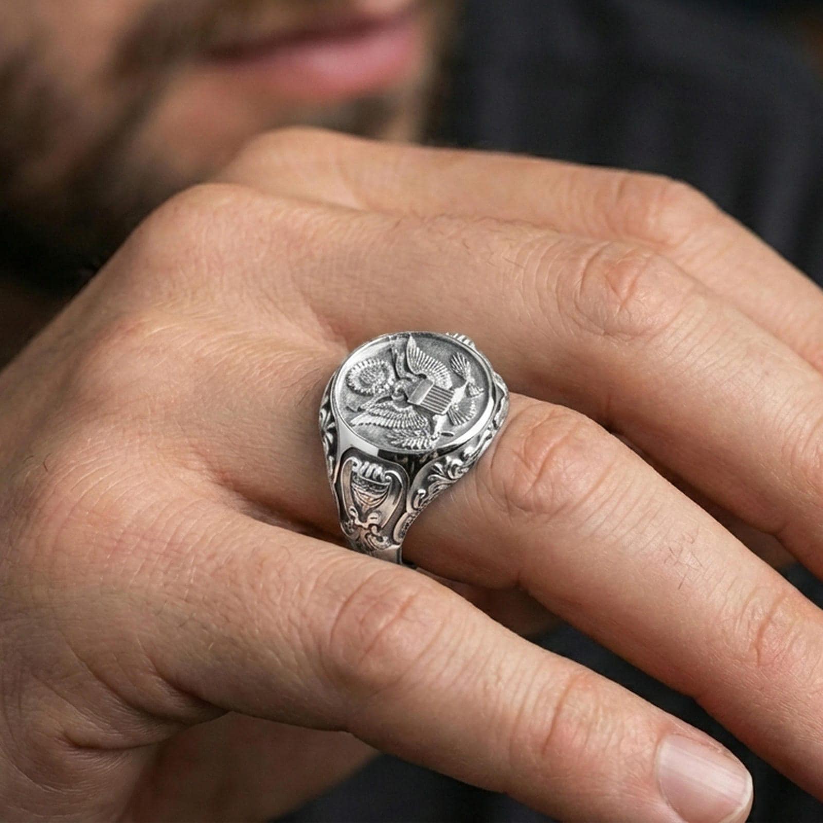 Polished silver finish US eagle seal signet ring on the finger, macro lifestyle image emphasizing the crisp crest details and classic signet shape