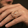 Load image into Gallery viewer, Rose gold plated finish skull and eagle ring on the finger, macro lifestyle shot showcasing the sculpted wings, talon details, and heavy signet look
