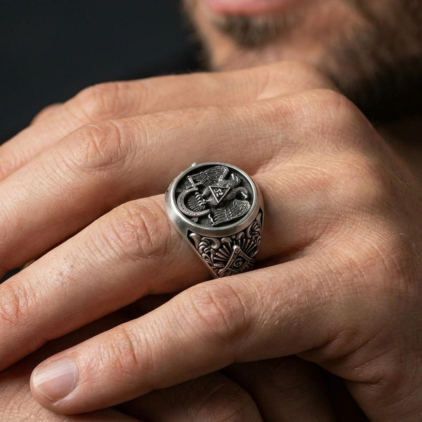 Oxidized finish Masonic double-headed eagle ring worn on a finger, close-up lifestyle shot highlighting the “32” triangle emblem and deep relief