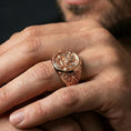 Load image into Gallery viewer, Rose gold plated finish Masonic double-headed eagle ring on the finger, macro lifestyle shot emphasizing the vintage-style relief and symbolic side motifs
